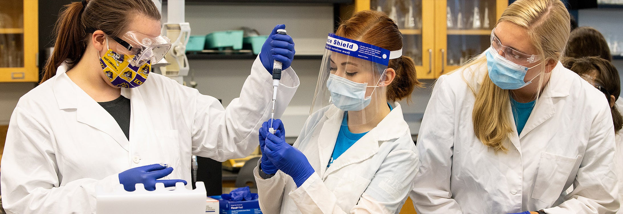 Three students participating in a Course based Undergraduate Research Experiences (CUREs) at ECU