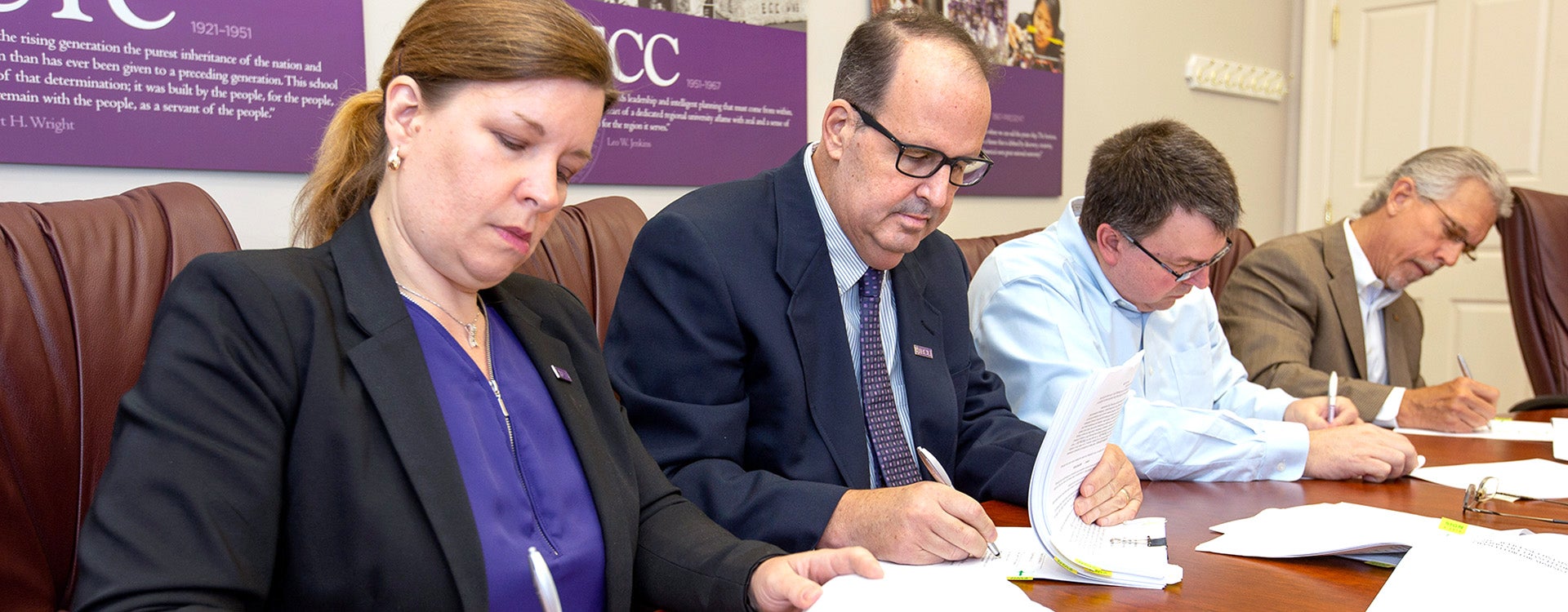 Vice Chancellor for Administration and Finance Sara Thorndike, from left, Vice Chancellor of Research, Economic Development and Engagement Professor Dr. Jay S. Golden, Assistant Dean for Dental Education and Informatics Todd Watkins and XComP President Danny W. Mills sign documents securing an exclusive license agreement between ECU and XComP Analytics, Inc. (Photo by Rhett Butler)