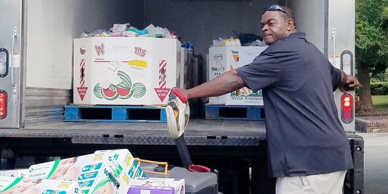 volunteer helps load supplies from ECU’s Hurricane Florence Food Drive into a truck for the Food Bank of Central and Eastern North Carolina. As of Sept. 24, the food drive brought in more than 6,200 pounds of water, food and household supplies. (Submitted Photos)
