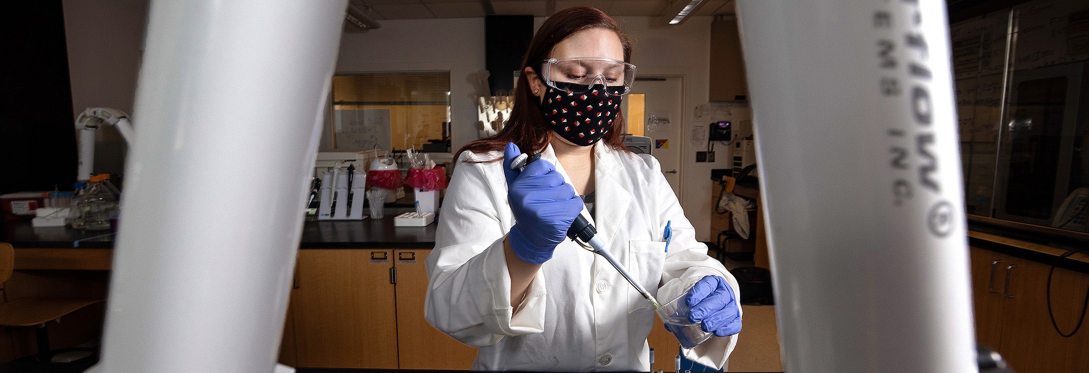 ECU student Kristin Tyson works in a lab.(Photo by Rhett Butler)